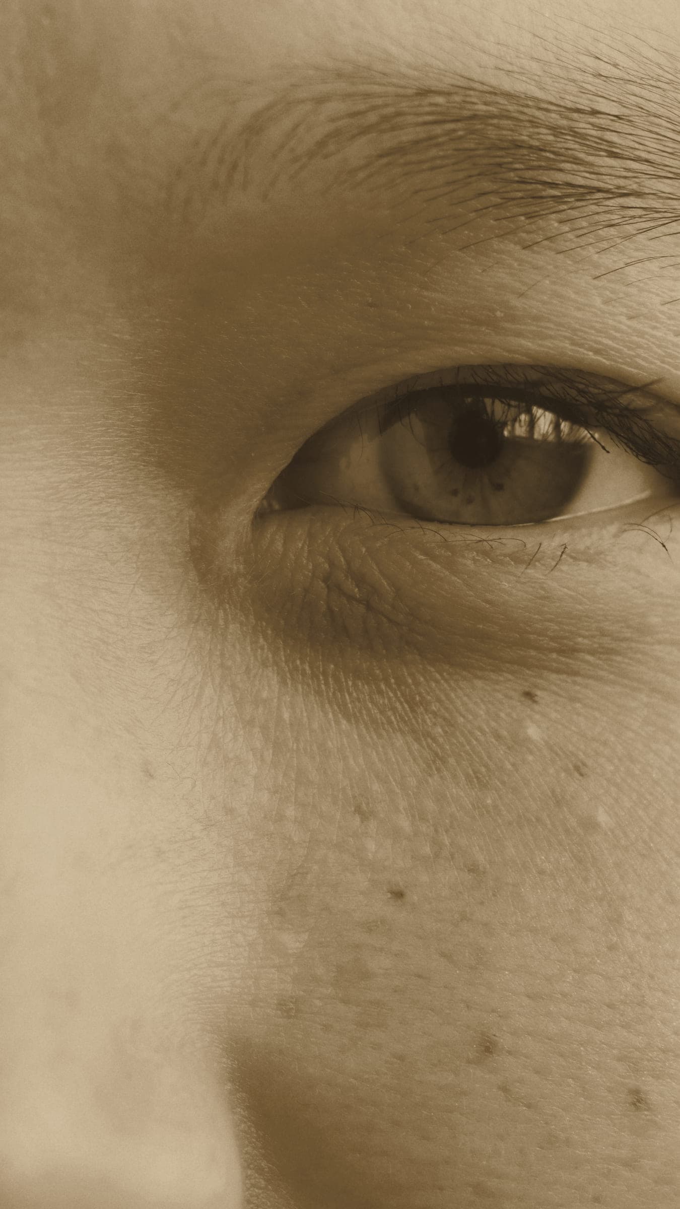 An extreme close-up of skin beneath an eye, with natural texture and fine pores visible.
